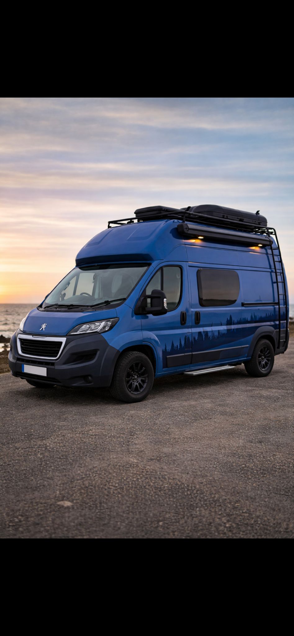 Blue campervan conversion at sunset